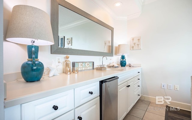 interior space featuring vanity, tile patterned floors, and ornamental molding