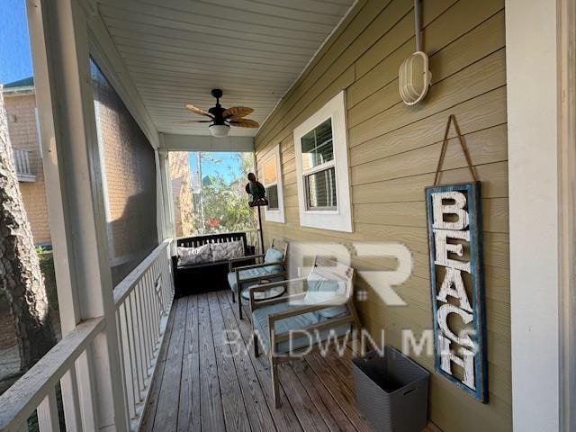 wooden deck featuring ceiling fan