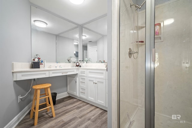 bathroom featuring vanity, hardwood / wood-style floors, and walk in shower