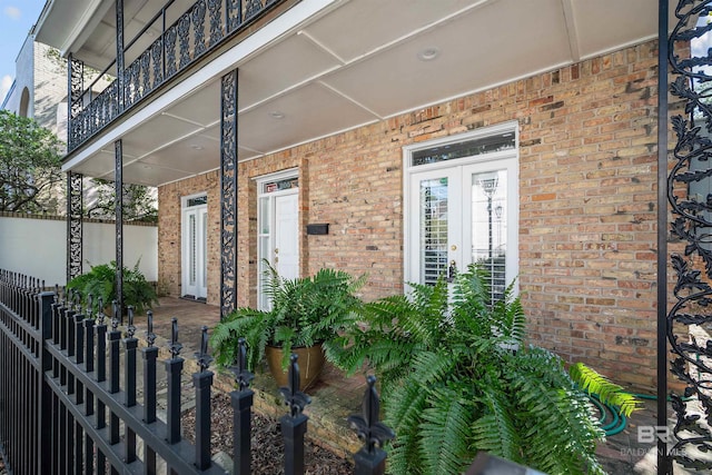 entrance to property with a balcony and french doors