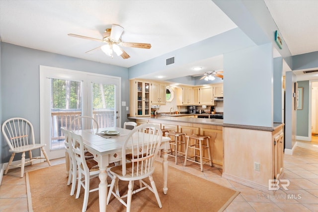 dining space featuring light tile patterned floors and sink