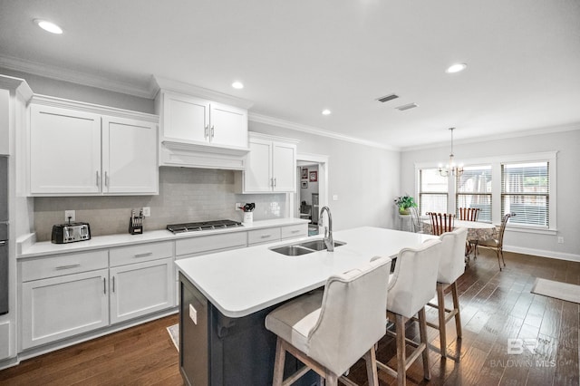 kitchen featuring sink, dark wood-type flooring, white cabinetry, a center island with sink, and custom exhaust hood