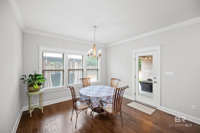 dining space with ornamental molding, dark hardwood / wood-style flooring, and a chandelier