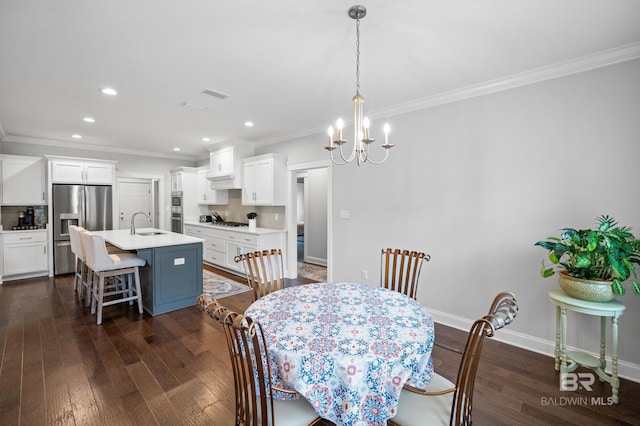 dining area with dark wood-type flooring, ornamental molding, and sink