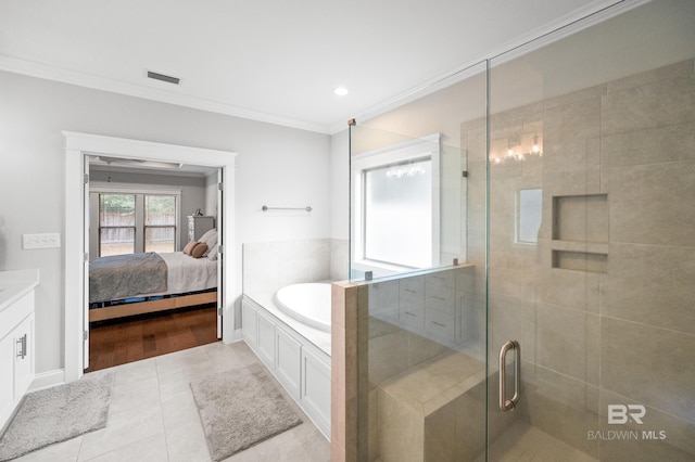 bathroom with tile patterned flooring, vanity, ornamental molding, and independent shower and bath