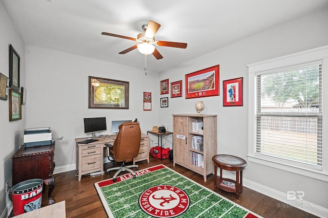 home office with dark wood-type flooring and ceiling fan