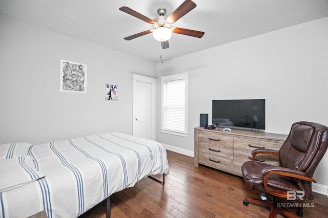 bedroom with dark hardwood / wood-style flooring and ceiling fan