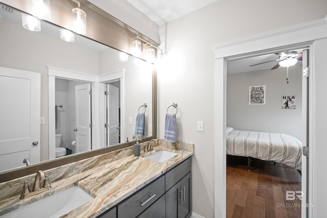 bathroom with vanity, ceiling fan, wood-type flooring, and toilet