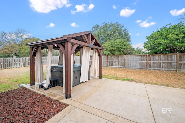 view of patio featuring a gazebo and a hot tub