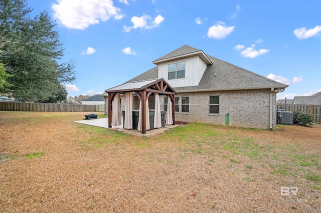 rear view of house with a yard, a patio area, and central air condition unit