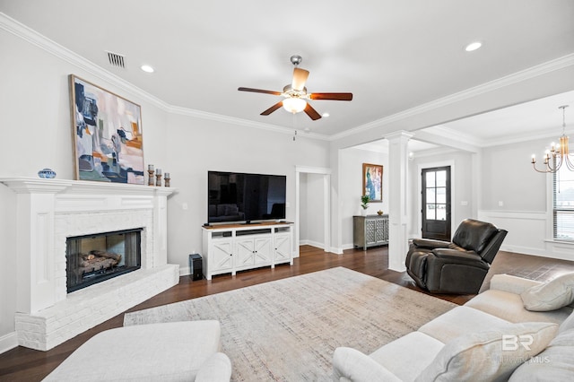 living room featuring ornamental molding, a brick fireplace, and dark hardwood / wood-style flooring