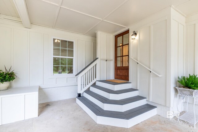 stairs with concrete flooring