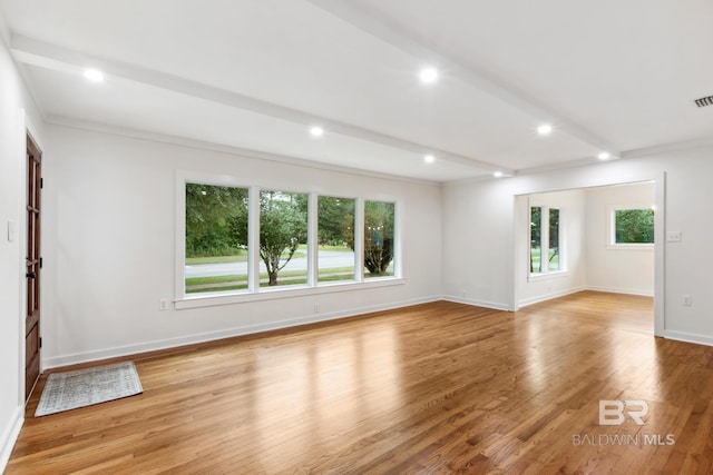 spare room with visible vents, light wood finished floors, baseboards, recessed lighting, and beam ceiling
