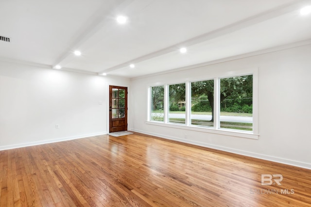 unfurnished room featuring light wood-type flooring, visible vents, baseboards, beamed ceiling, and recessed lighting