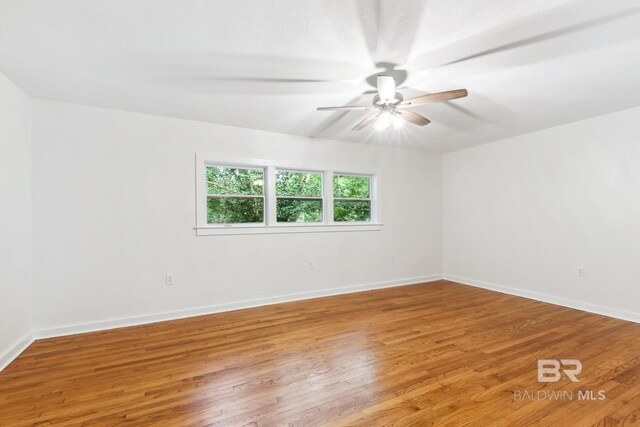 unfurnished room with ceiling fan and hardwood / wood-style floors