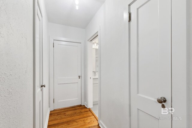 corridor featuring wood-type flooring