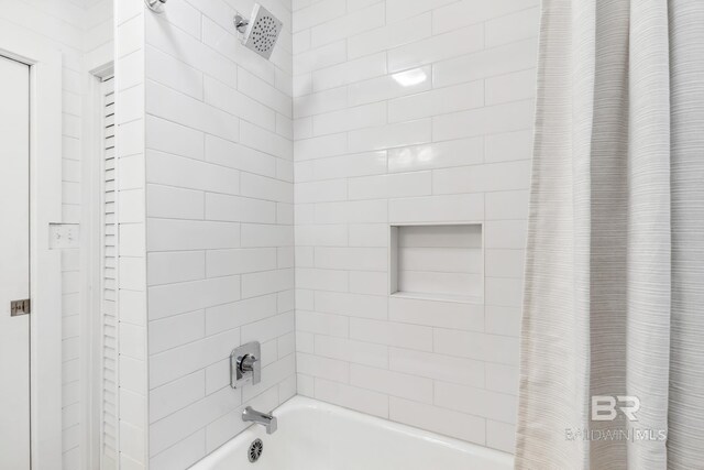 bathroom featuring shower / tub combo with curtain