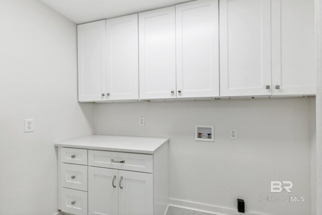 laundry room featuring hookup for a washing machine and cabinets