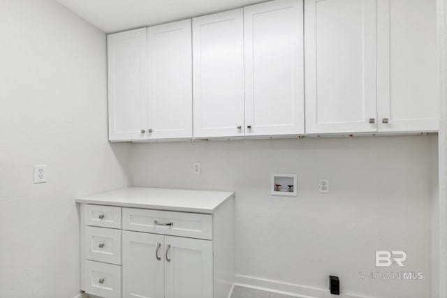 laundry area with washer hookup, cabinet space, and baseboards