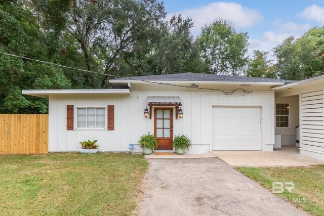 ranch-style house with a front yard and a garage