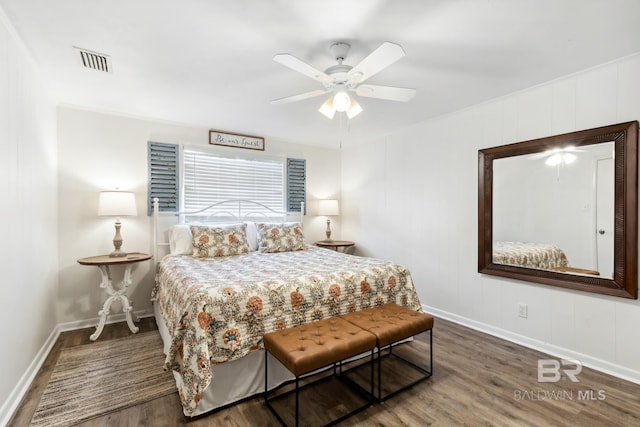 bedroom featuring baseboards, visible vents, a ceiling fan, and wood finished floors