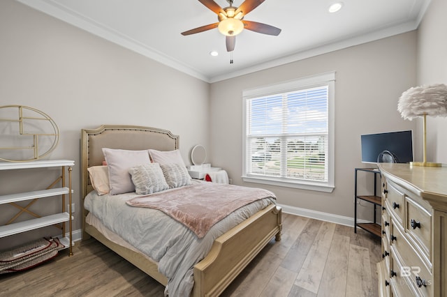 bedroom featuring ceiling fan, ornamental molding, and hardwood / wood-style flooring