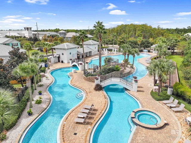 view of pool with a hot tub