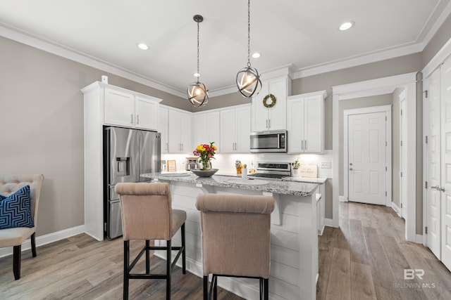 kitchen with a center island with sink, light hardwood / wood-style floors, white cabinetry, and stainless steel appliances