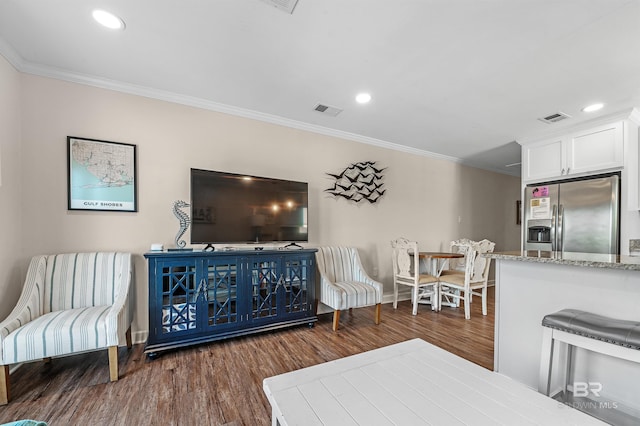 living room featuring dark hardwood / wood-style flooring and ornamental molding