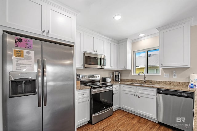 kitchen featuring light hardwood / wood-style floors, sink, white cabinets, and stainless steel appliances