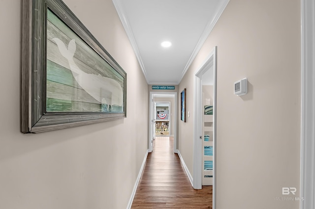 corridor with hardwood / wood-style floors and ornamental molding