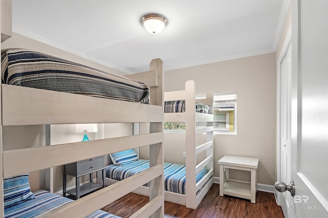 bedroom featuring crown molding and dark hardwood / wood-style flooring