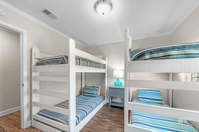 bedroom featuring hardwood / wood-style flooring and ornamental molding