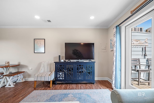 living room featuring ornamental molding and hardwood / wood-style floors