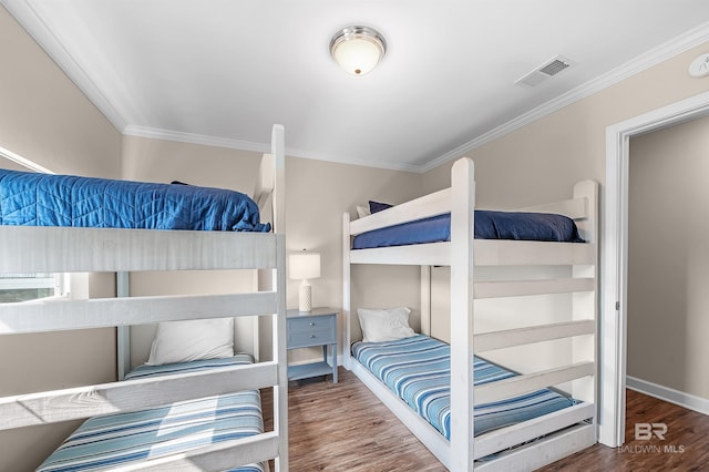 bedroom featuring crown molding and hardwood / wood-style floors