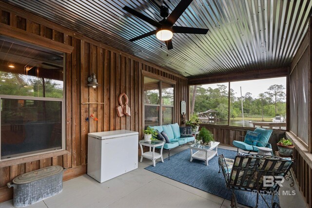 sunroom with an outdoor living space and ceiling fan