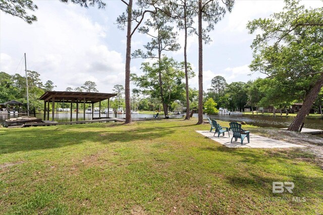 surrounding community featuring a water view and a yard