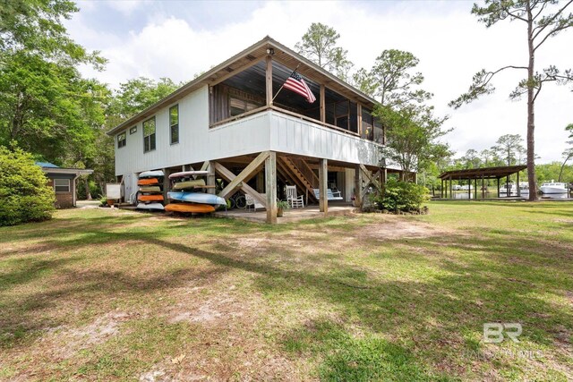 rear view of house with a yard and stairway