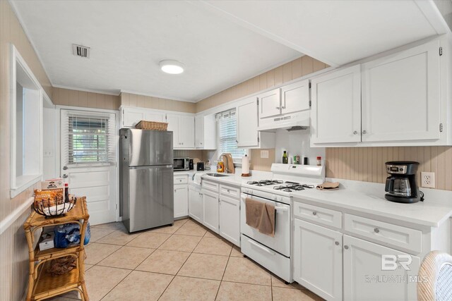 kitchen featuring visible vents, under cabinet range hood, white cabinets, a sink, and stainless steel appliances