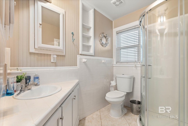 bathroom with visible vents, tile patterned flooring, a shower stall, vanity, and toilet