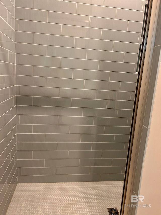 bathroom with tiled shower