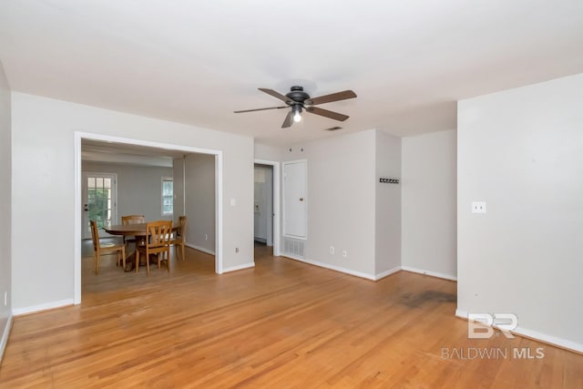 spare room with ceiling fan and light wood-type flooring