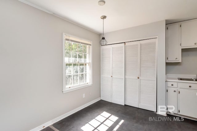 unfurnished bedroom featuring sink and a closet