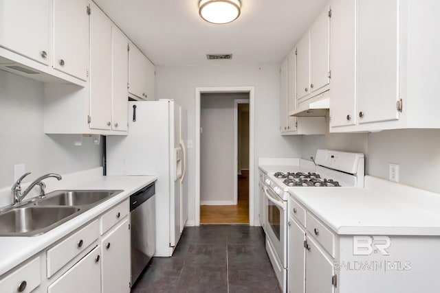 kitchen with white cabinets, white gas range oven, and sink