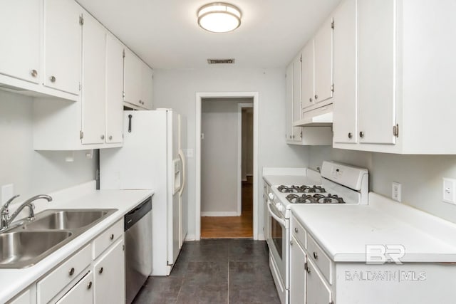 kitchen featuring dishwasher, gas range gas stove, sink, white cabinets, and dark hardwood / wood-style flooring