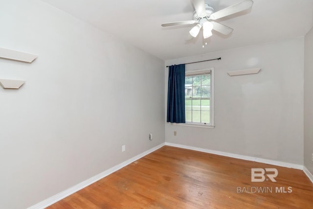 spare room featuring wood-type flooring and ceiling fan