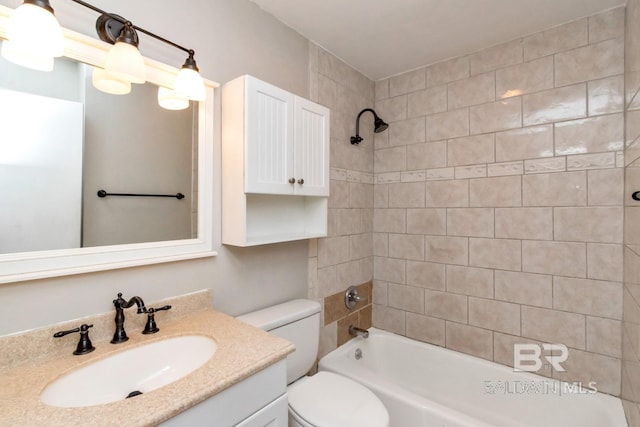 full bathroom with vanity, tiled shower / bath combo, and toilet