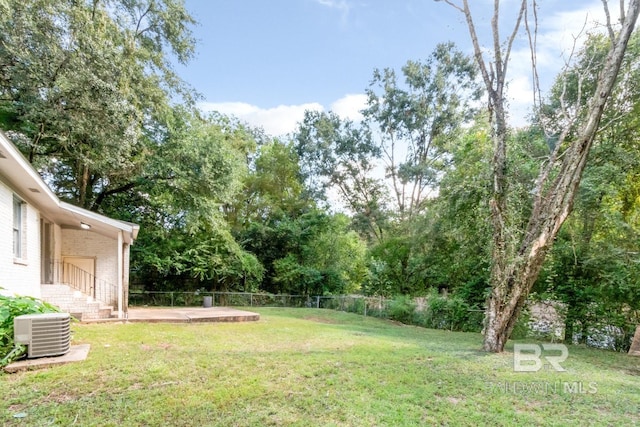 view of yard featuring a patio area and central air condition unit