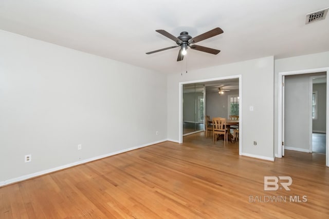 unfurnished bedroom with wood-type flooring, ceiling fan, and a closet