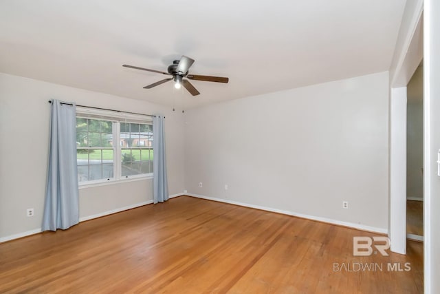 spare room featuring wood-type flooring and ceiling fan